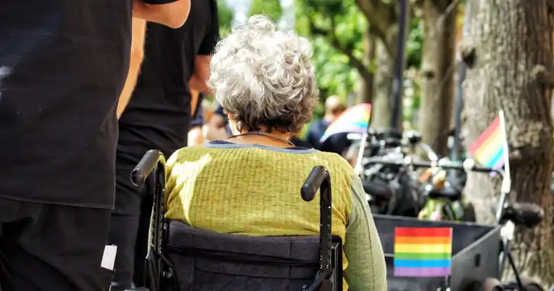 Stock photo of a person in a wheelchair at a Pride parade
