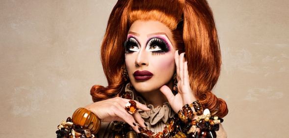 A promo image of drag queen Bianca Del Rio wearing an orange wig and dress