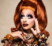 A promo image of drag queen Bianca Del Rio wearing an orange wig and dress