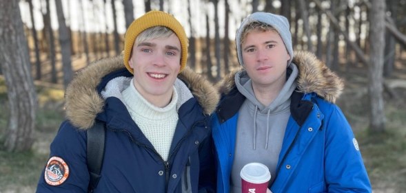 Kieran (L) and Steven Douglas-Lane in puffer jackets standing in the forest