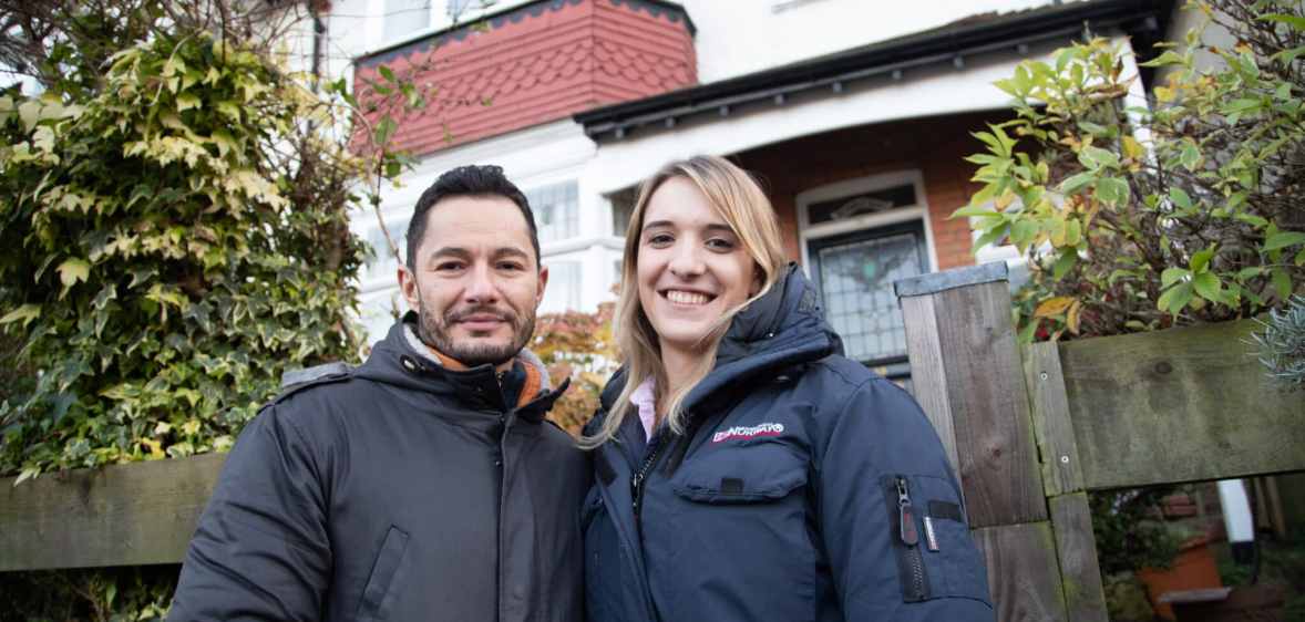 Hannah and Jake Graf pose outside their London home
