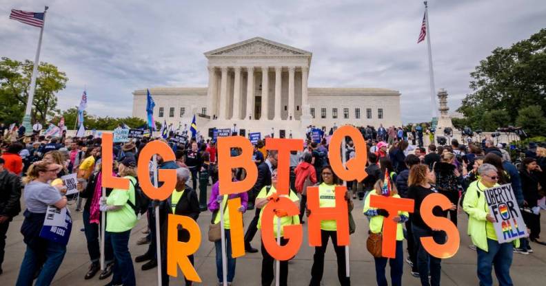 Protesters holding a banner reading "LGBTQ Rights" outside the Supreme Court in Washington DC