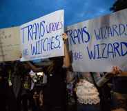 Protesters hold signs calling out JK. Rowling's twitter comments