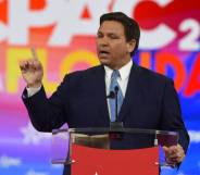 Ron DeSantis, the governor of Florida, wears a dark suit with a blue tie while addressing attendees at the 2022 Conservative Political Action Conference