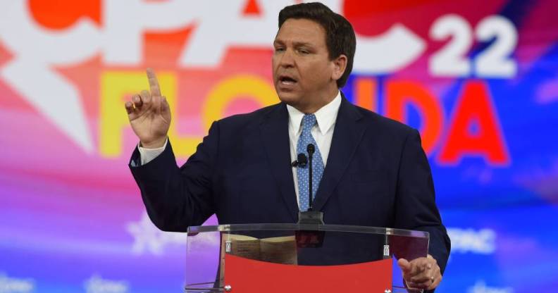 Ron DeSantis, the governor of Florida, wears a dark suit with a blue tie while addressing attendees at the 2022 Conservative Political Action Conference