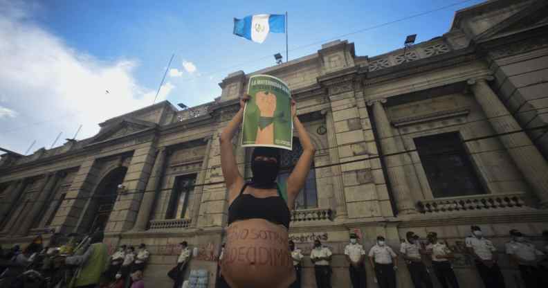 People protest against an anti-abortion and anti-LGBT+ bill outside of the Guatemalan Congress in Guatemala City on 15 March 2022