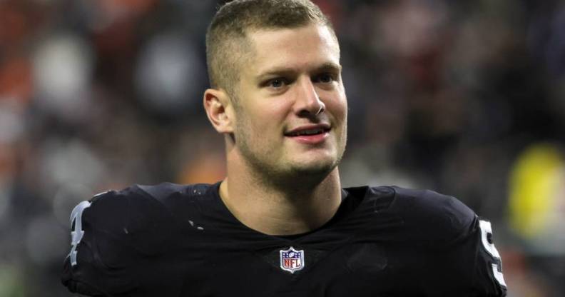 Carl Nassib, a player for the Las Vegas Raiders, walks off the field while wearing a football jersey