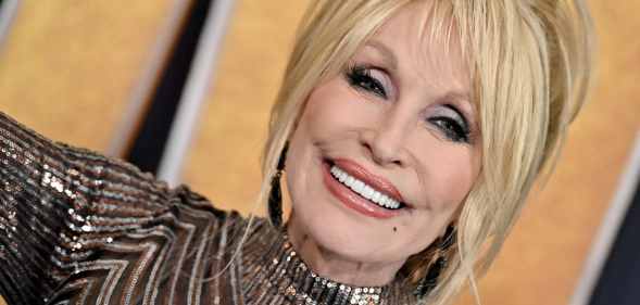 Dolly Parton smiles as she attends the 57th Academy of Country Music Awards