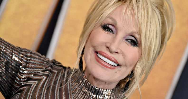 Dolly Parton smiles as she attends the 57th Academy of Country Music Awards