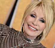 Dolly Parton smiles as she attends the 57th Academy of Country Music Awards