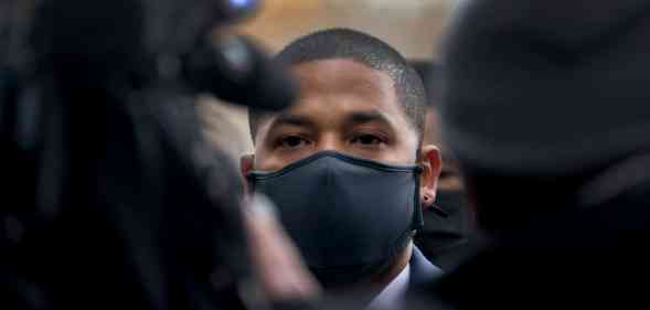 Jussie Smollett in front of several people and cameras