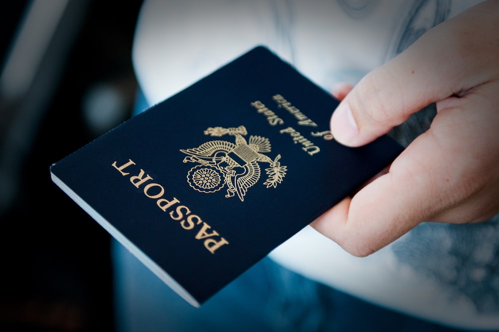 A hand holds a US passport