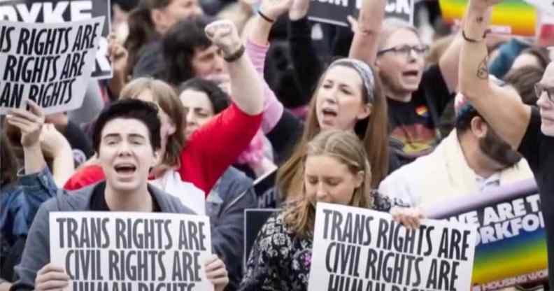People holding up signs that read "Trans rights are civil rights are human rights"