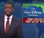 SNL castmate Michael Che during the Weekend Update segment with a picture of Florida alongside the Walt Disney Company logo and a news bulletin about the state's "Don't Say Gay" bill