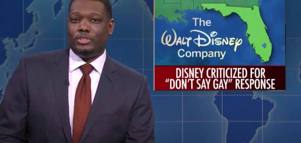 SNL castmate Michael Che during the Weekend Update segment with a picture of Florida alongside the Walt Disney Company logo and a news bulletin about the state's "Don't Say Gay" bill