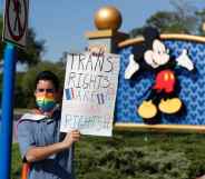 A Disney holds a sign while protesting outside of Walt Disney World on March 22, 2022 in Orlando, Florida.