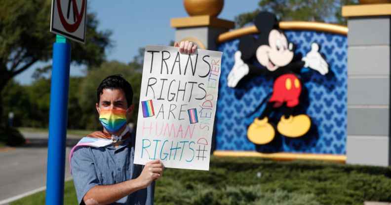 A Disney holds a sign while protesting outside of Walt Disney World on March 22, 2022 in Orlando, Florida.
