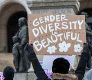 A protester holding a sign reading "gender diversity is beautiful