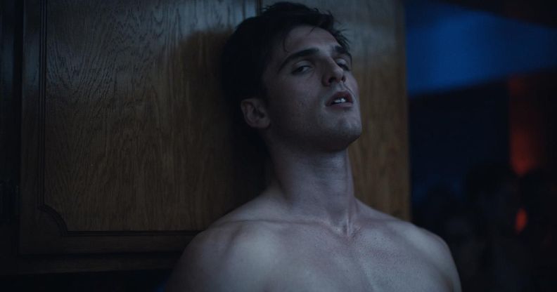 Jacob Elordi as Nate in Euphoria, standing topless against a wall