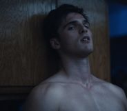 Jacob Elordi as Nate in Euphoria, standing topless against a wall
