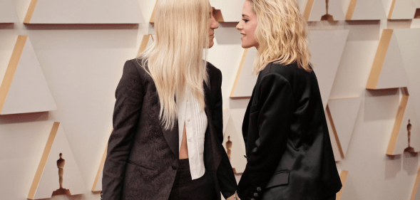 Kristen Stewart and her fiancée Dylan Meyer at the Oscars, leaning in for a kiss