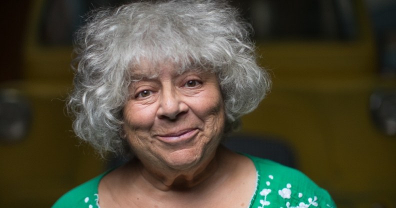 Miriam Margolyes standing in front of a yellow van