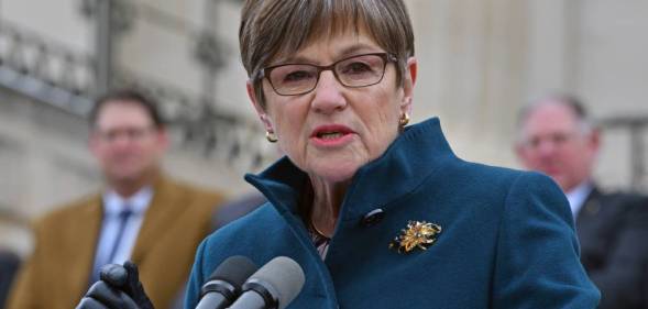 Kansas governor Laura Kelly addresses a crowd as she stands at a podium
