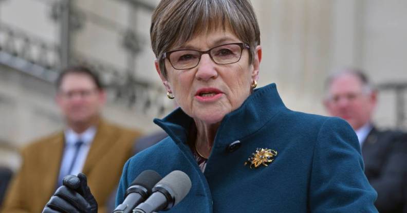 Kansas governor Laura Kelly addresses a crowd as she stands at a podium