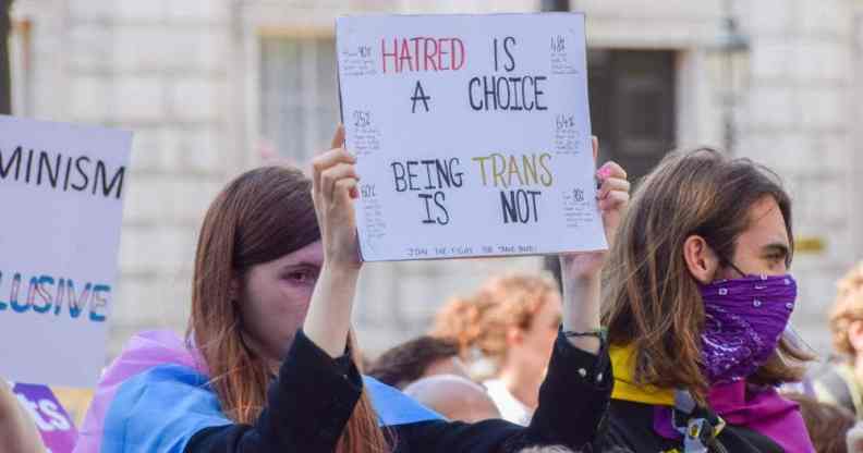 A protester holds a placard that says "Hatred is a choice, being trans is not" during a trans rights demonstration