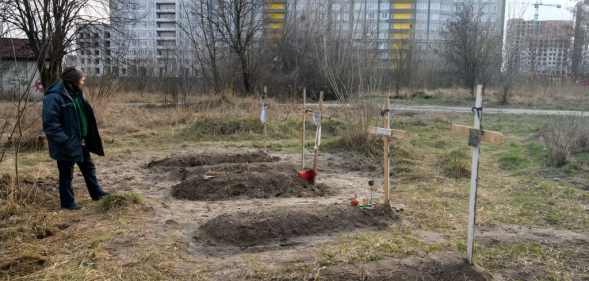 Graves with bodies of civilians next to apartments blocks in the recaptured by the Ukrainian army Bucha city near Kyiv, Ukraine, 04 April 2022.