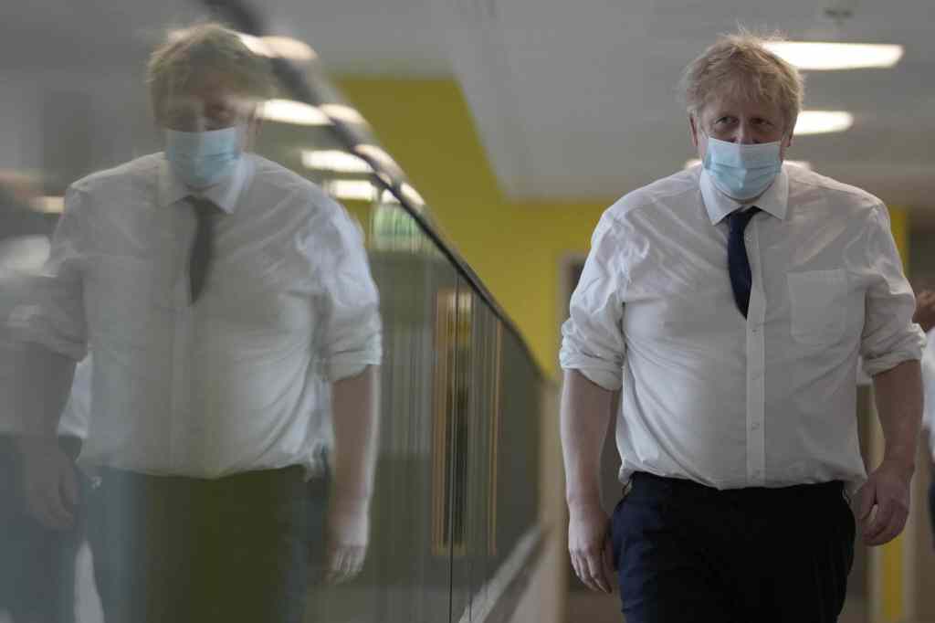 Boris Johnson walks through a hospital corridor