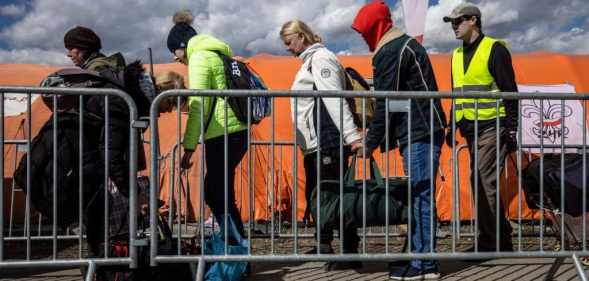 Refugees from Ukraine wait for the bus after they crossed the Ukrainian-Polish border at the border crossing in Medyka, southeastern Poland on April 8, 2022.
