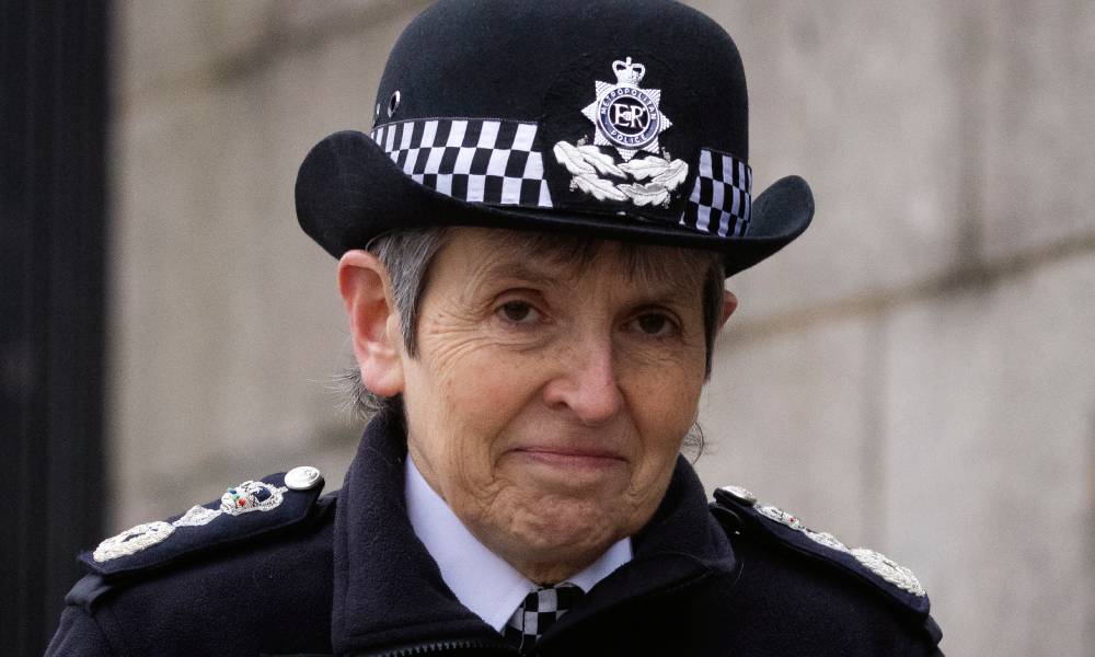Outgoing Metropolitan Police commissioner Cressida Dick stares at the camera while wearing a black and white police uniform
