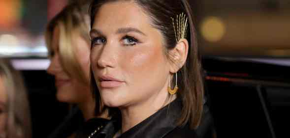 Kesha looks forward at a red carpet event