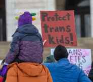 Protester holds a sign that reads 'protect trans kids'