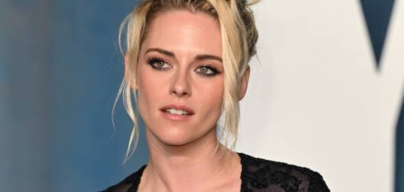 Kristen Stewart poses for the camera while wearing a black lacy outfit
