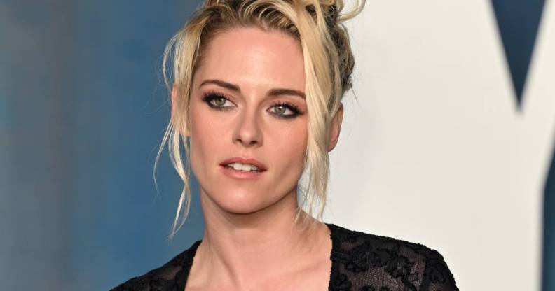 Kristen Stewart poses for the camera while wearing a black lacy outfit