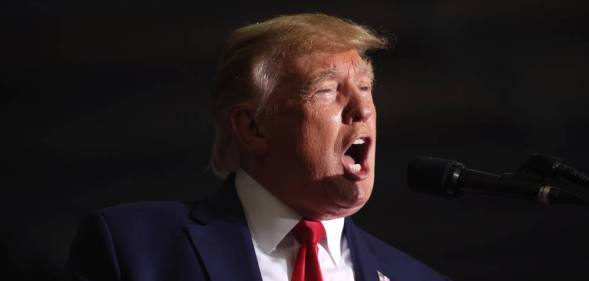 Former president Donald Trump speaks into a microphone