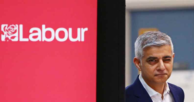 Sadiq Khan stands to a sign reading: 'London Labour'
