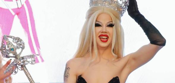 Willow Pill smiles and holds up their crown and sceptre as they are crowned the winner of Drag Race season 14