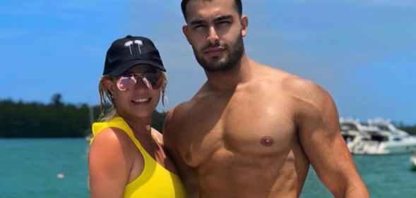 Sam Asghari and Britney Spears pose by the sea