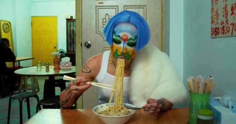 Non-binary artist Sin Wai Kin eats noodles during their film "A Dream of Wholeness in Parts"
