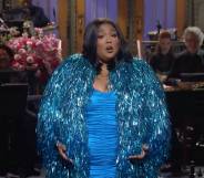 Lizzo wears a bright blue dress and a sparkly blue jacket during her opening monologue on Saturday Night Live