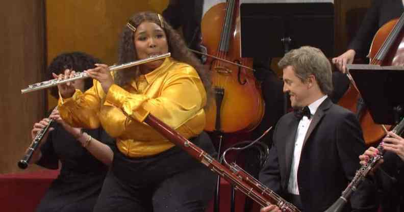 Lizzo plays the flute as she twerks during a skit on Saturday Night Live