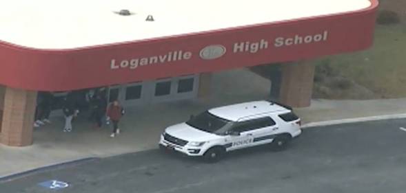 A picture of Loganville High School in Georgia from a distant with a police car outside the school's entrance investigating an alleged homophobic attack against a student