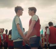 a still image of Heartstopper characters Nick and Charlie on a rugby field