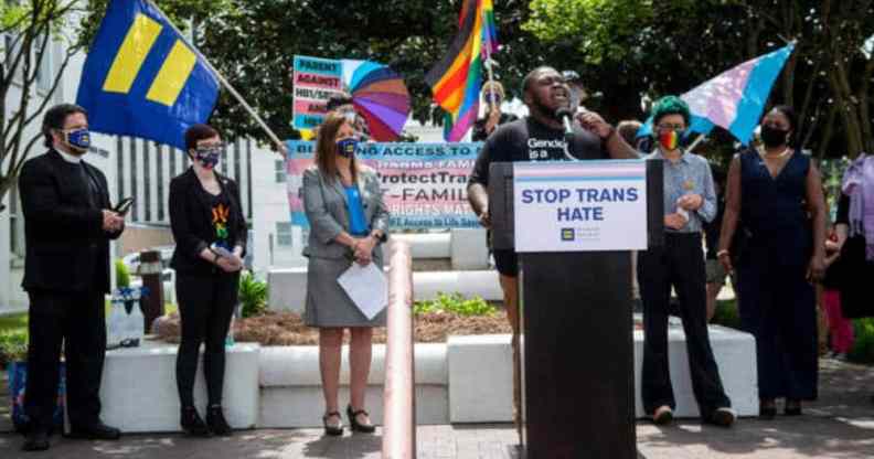 The Knights and Orchids Society speaks at a rally on behalf of trans youth