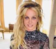 Britney Spears poses in a metallic dress