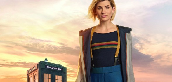 Jodie Whittaker as The Doctor, with a TARDIS in the background
