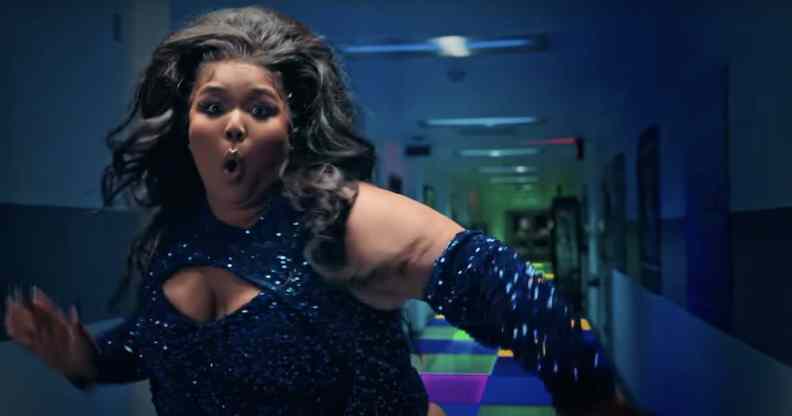 Lizzo in sequins, dancing in front of a hallway with a light-up floor
